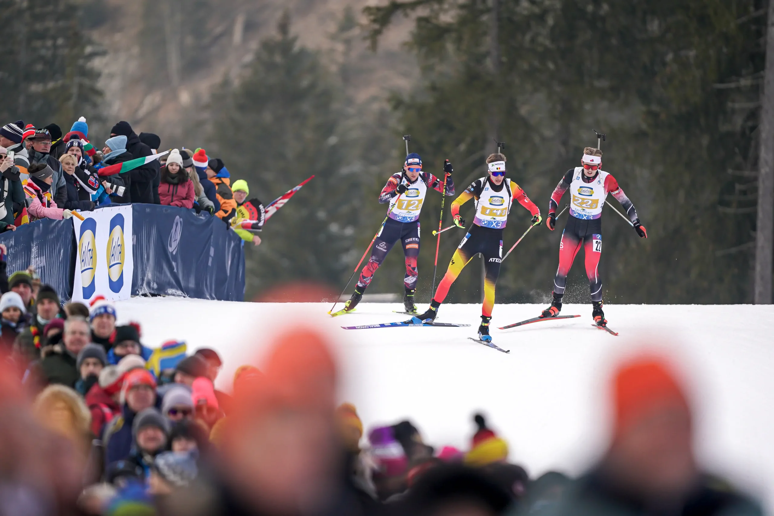 Three biatlethes in the snow
